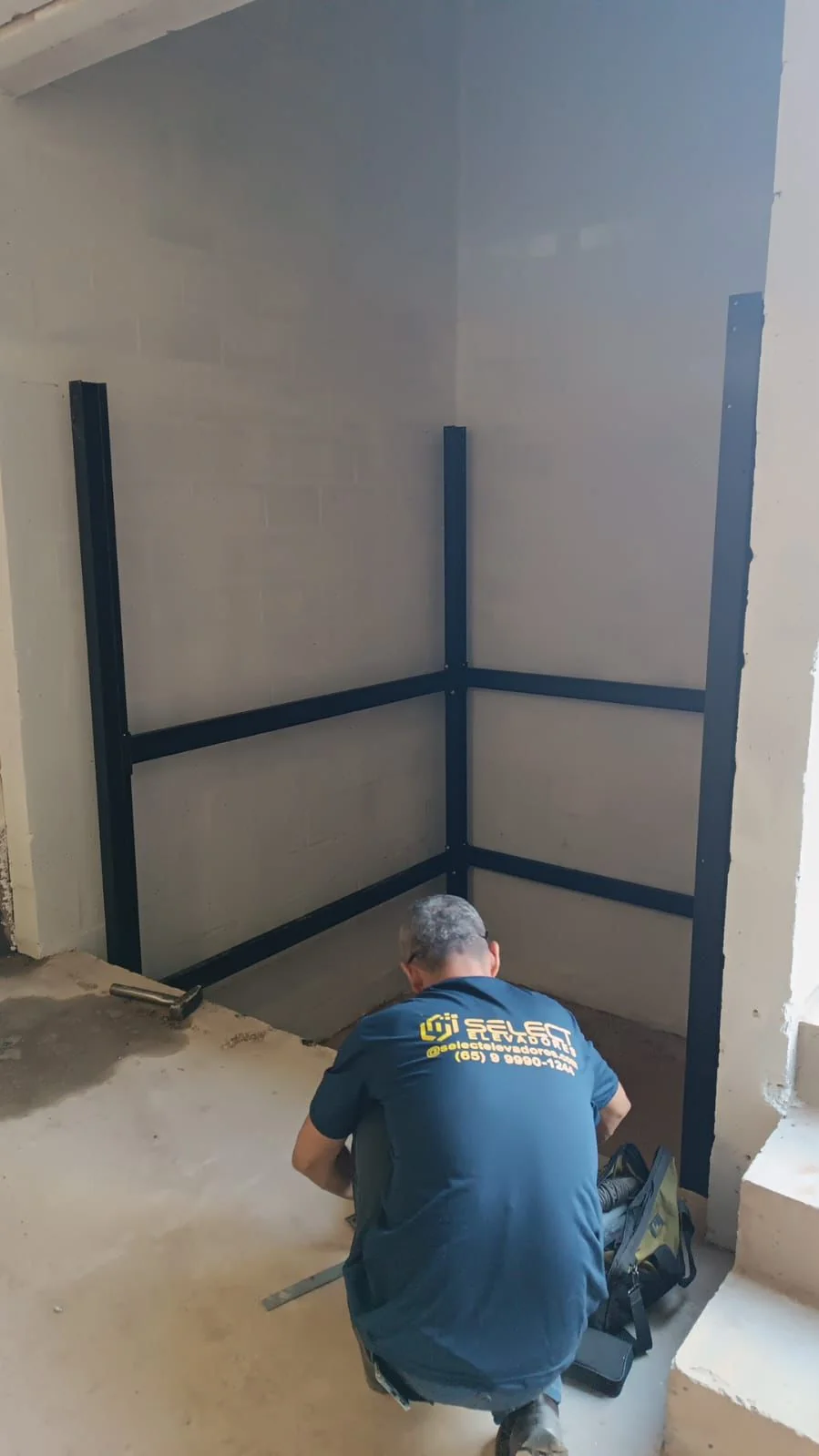 Técnico Select instalando trilhos no poço durante montagem